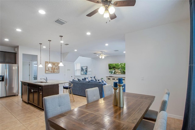 tiled dining area with sink and ceiling fan