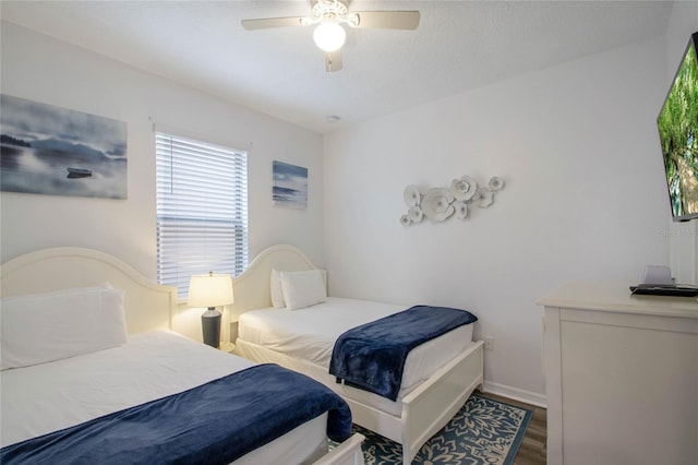 bedroom with wood-type flooring and ceiling fan