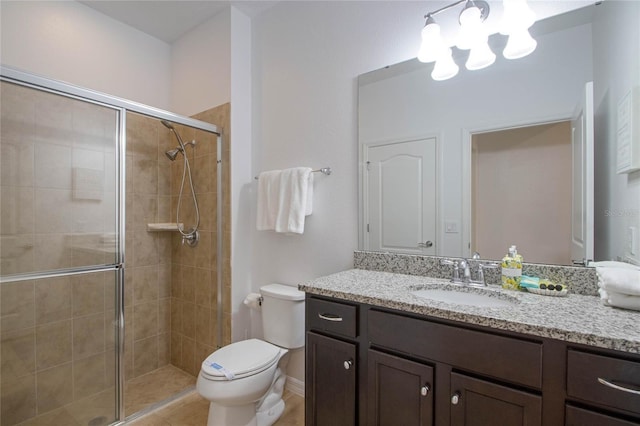 bathroom featuring vanity, an enclosed shower, and toilet