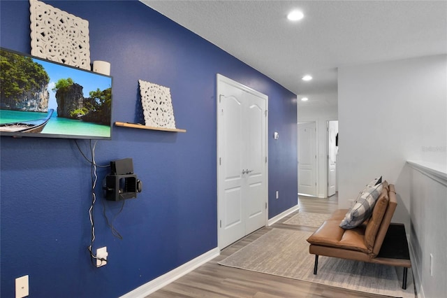 foyer featuring hardwood / wood-style flooring and a textured ceiling