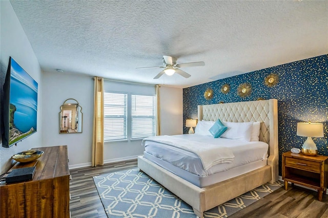 bedroom featuring ceiling fan, dark wood-type flooring, and a textured ceiling