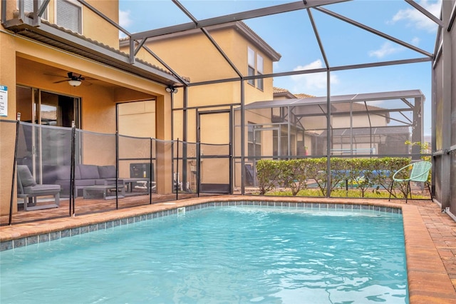 view of pool with a lanai, pool water feature, and ceiling fan