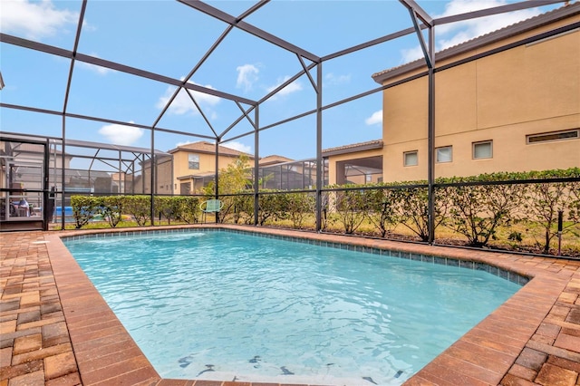 view of pool featuring a patio and glass enclosure