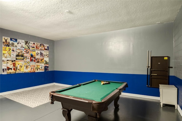 recreation room with pool table, concrete flooring, and a textured ceiling