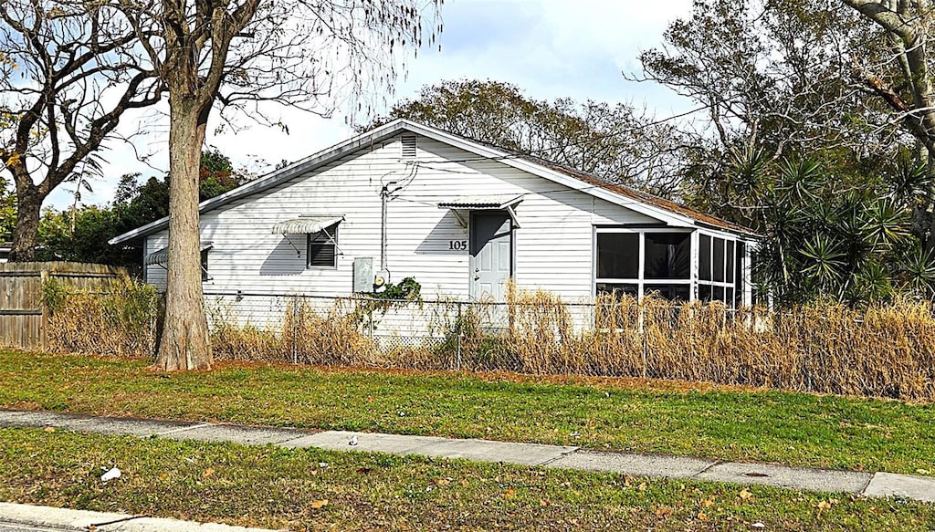 view of property exterior featuring a sunroom