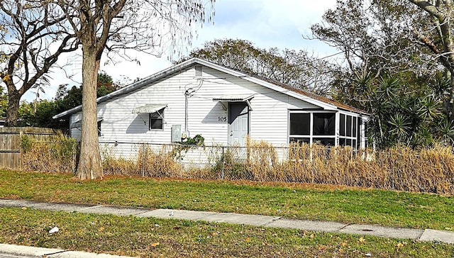 view of front of house featuring a sunroom and fence