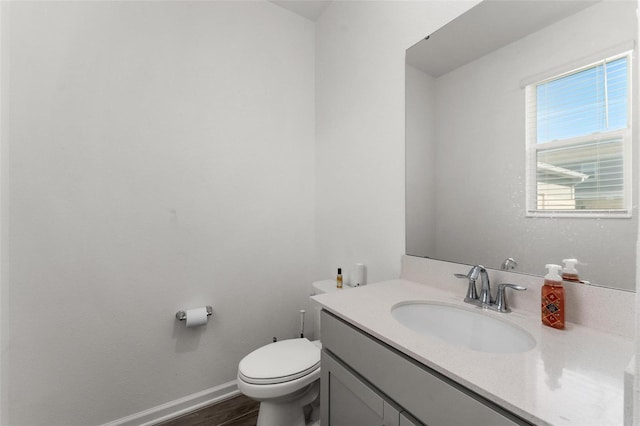 bathroom featuring vanity, hardwood / wood-style floors, and toilet