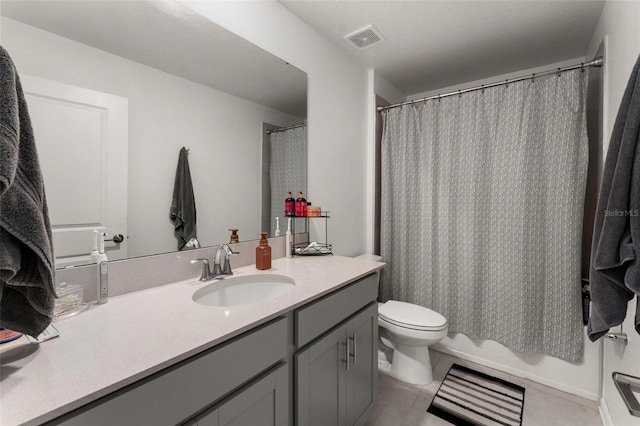 full bathroom featuring vanity, tile patterned flooring, toilet, and shower / tub combo with curtain