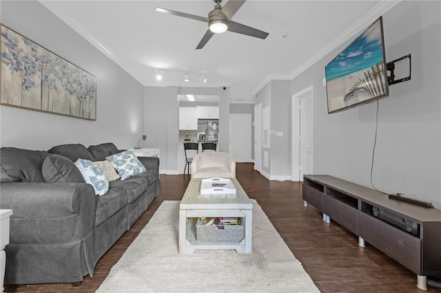 living room with ornamental molding, dark hardwood / wood-style floors, and ceiling fan