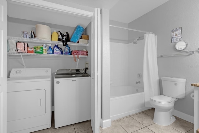 bathroom featuring shower / bathtub combination with curtain, washer and clothes dryer, tile patterned floors, and toilet