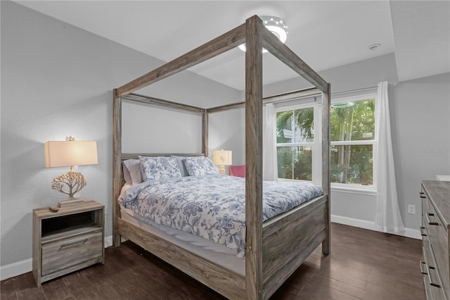 bedroom with dark hardwood / wood-style floors