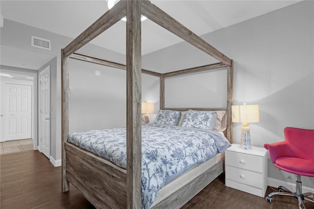 bedroom with dark hardwood / wood-style floors