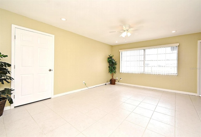 empty room with light tile patterned flooring and ceiling fan