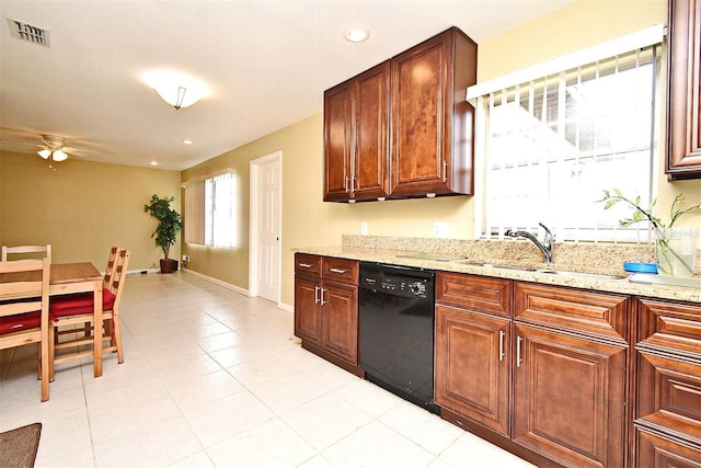 kitchen with light tile patterned flooring, dishwasher, sink, ceiling fan, and light stone counters