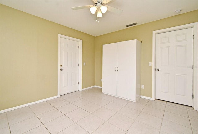 unfurnished bedroom with light tile patterned floors and ceiling fan