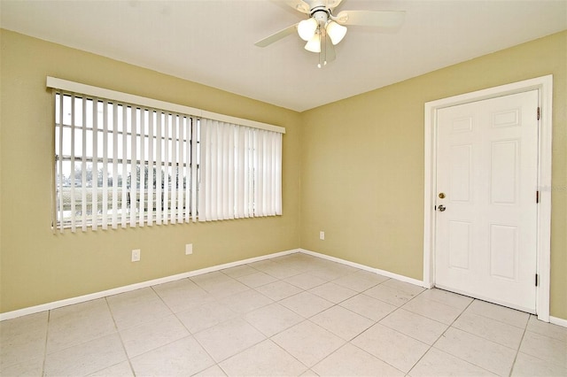 spare room featuring light tile patterned floors and ceiling fan