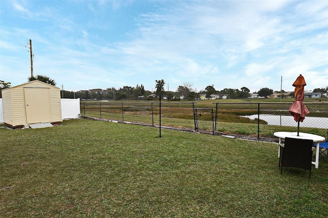 view of yard featuring a rural view and a storage shed