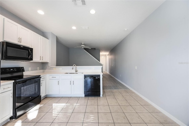 kitchen featuring sink, black appliances, and white cabinets