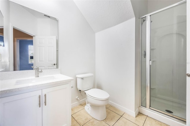 bathroom with toilet, vanity, tile patterned floors, and walk in shower