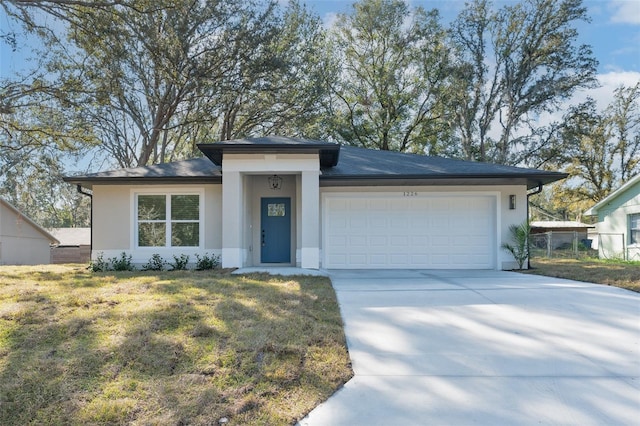 view of front facade with a garage and a front lawn