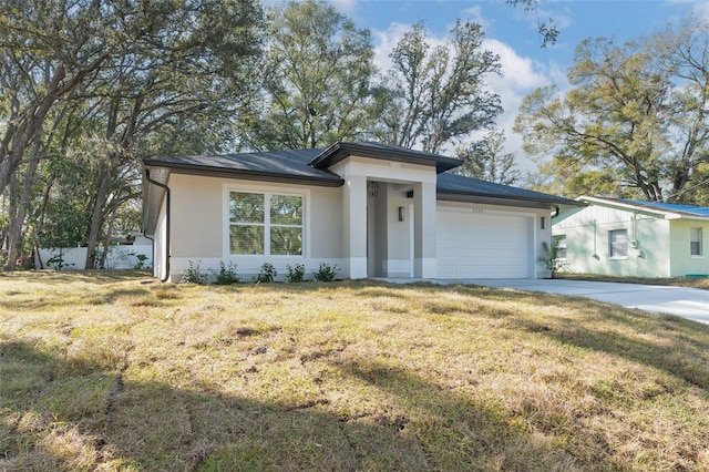 view of front of house with a garage and a front yard