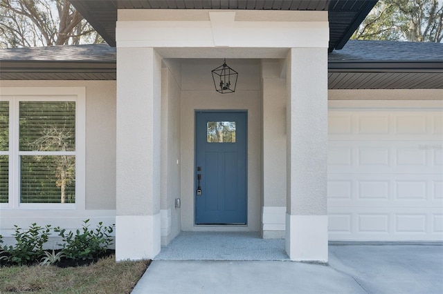 doorway to property with a garage