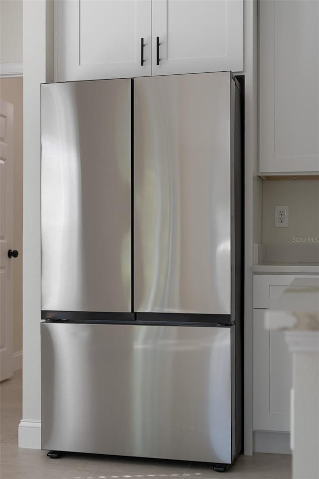 details featuring stainless steel refrigerator and white cabinets