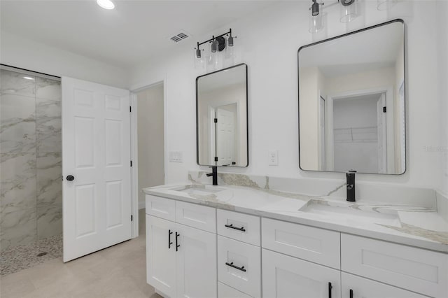 bathroom featuring vanity and a tile shower