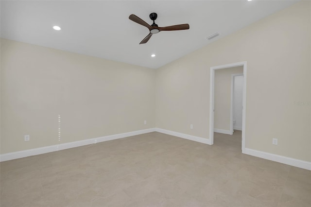 spare room featuring vaulted ceiling and ceiling fan