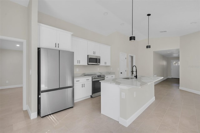 kitchen featuring sink, white cabinetry, hanging light fixtures, a center island with sink, and appliances with stainless steel finishes