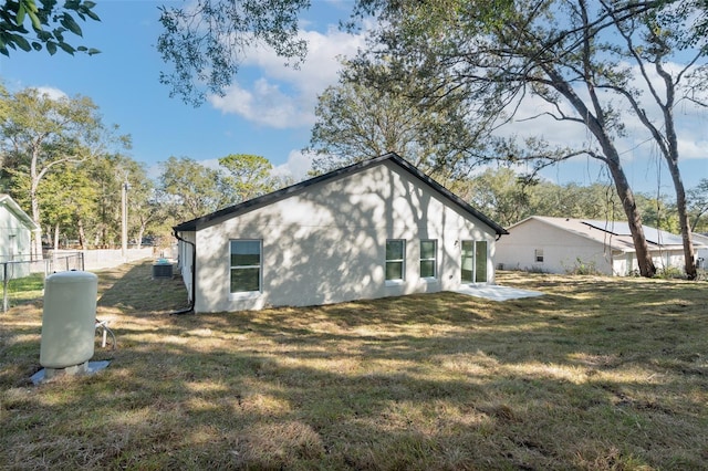 view of side of property with a lawn