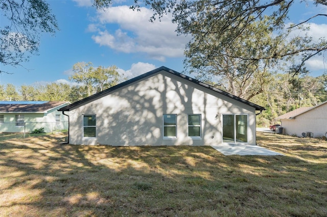 rear view of house with a yard and a patio area