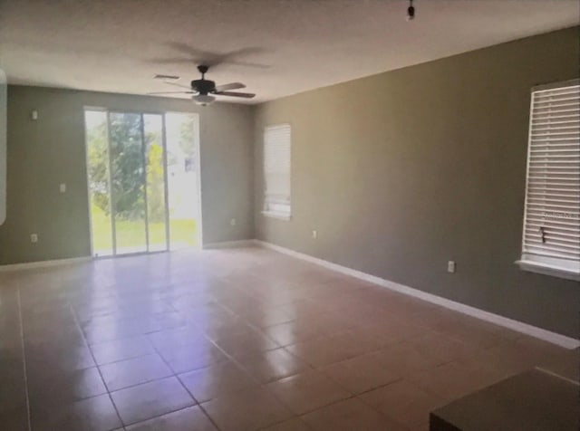 unfurnished room featuring tile patterned flooring and ceiling fan