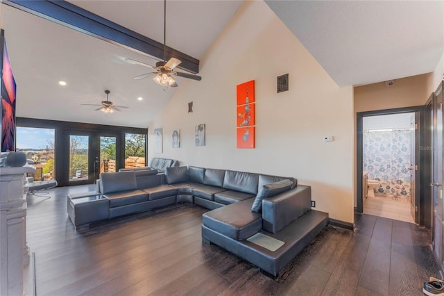 living room with dark wood-type flooring and high vaulted ceiling