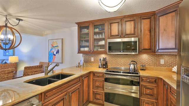 kitchen featuring sink, backsplash, hanging light fixtures, ornamental molding, and stainless steel appliances