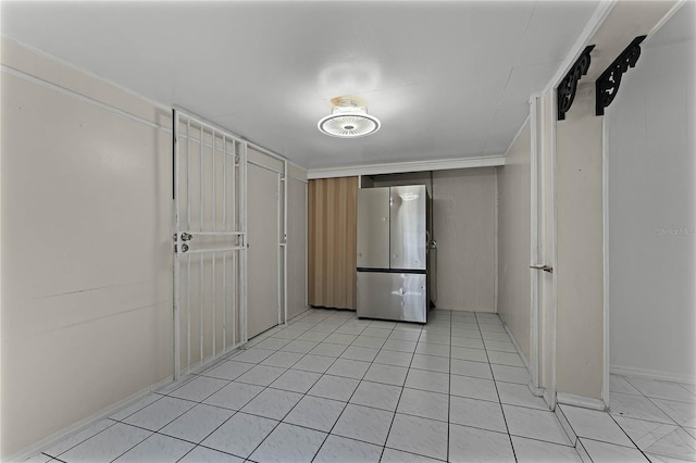 kitchen featuring light tile patterned floors and stainless steel fridge