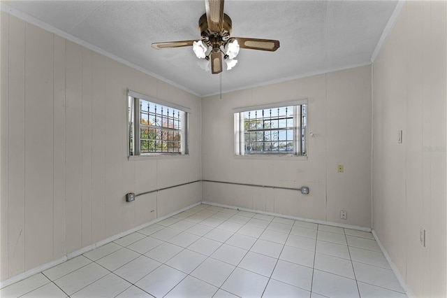 spare room with crown molding, a textured ceiling, and ceiling fan