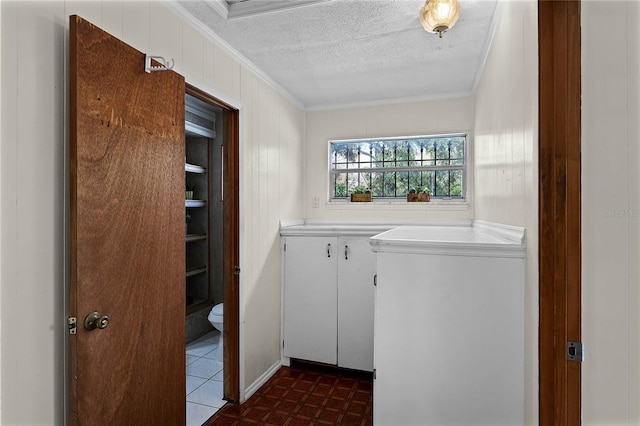 laundry area featuring crown molding and a textured ceiling