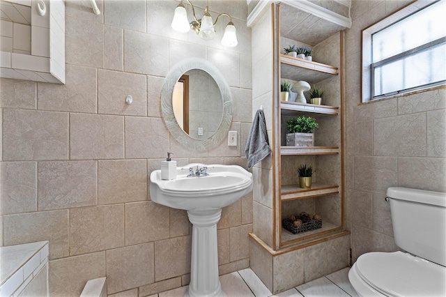 bathroom featuring toilet, tile walls, and built in shelves