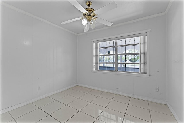 spare room featuring ornamental molding, ceiling fan, and light tile patterned flooring