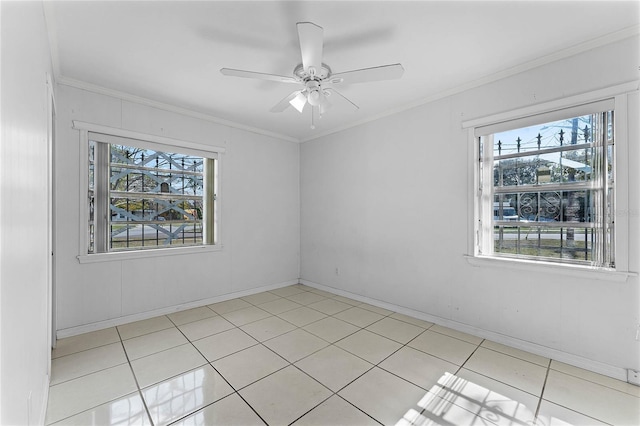 tiled spare room featuring crown molding and ceiling fan