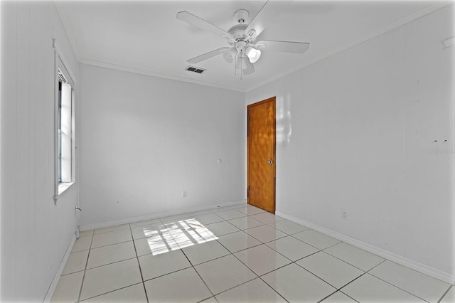 empty room with crown molding, ceiling fan, and light tile patterned flooring