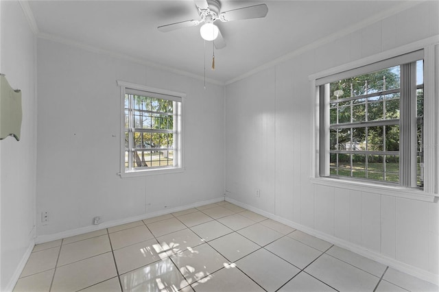 empty room featuring ornamental molding, light tile patterned floors, and ceiling fan