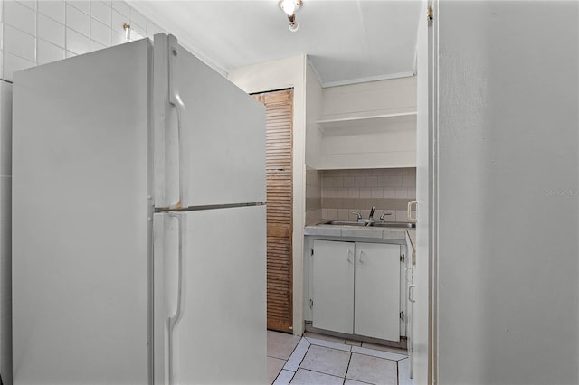 interior space with tile patterned flooring, vanity, and decorative backsplash