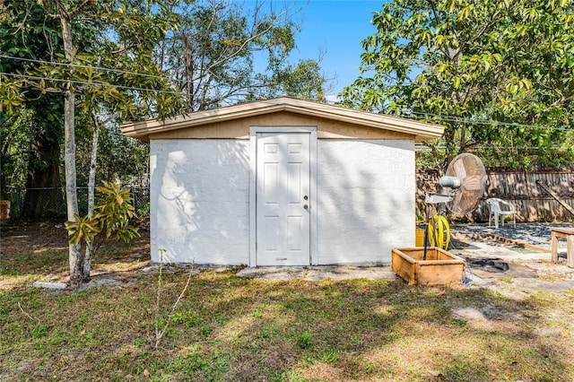 view of outbuilding featuring a yard