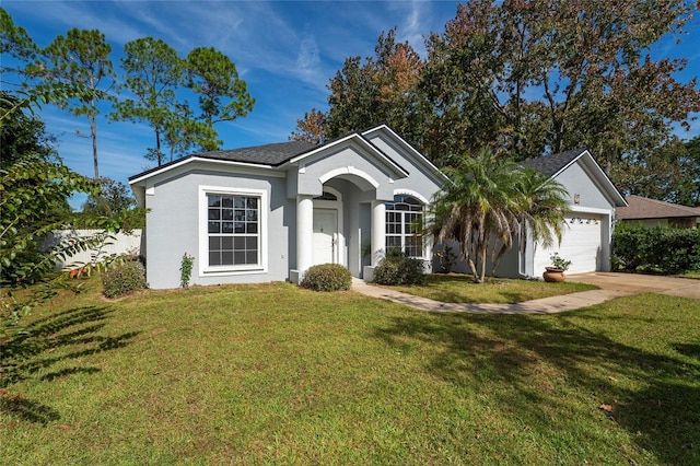 ranch-style house featuring a garage and a front lawn