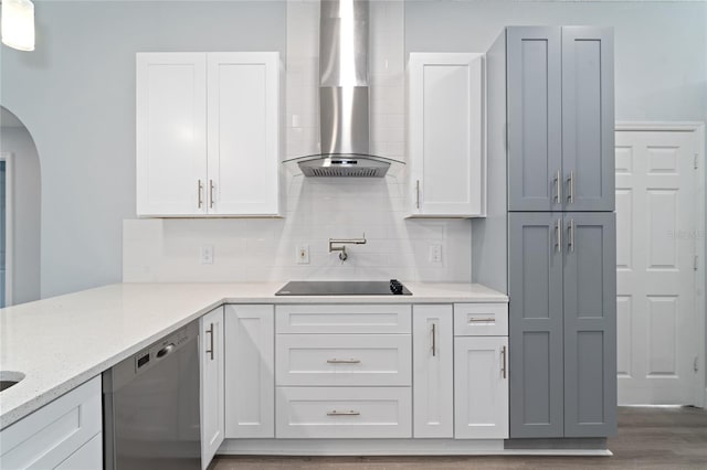 kitchen with tasteful backsplash, black electric cooktop, dishwasher, light stone countertops, and wall chimney range hood