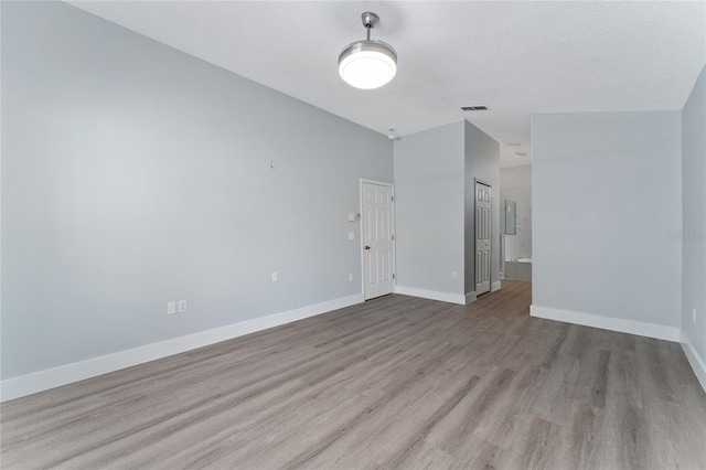 spare room featuring light hardwood / wood-style floors