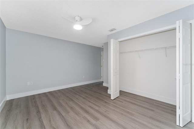 unfurnished bedroom with a closet and light wood-type flooring