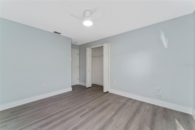 unfurnished bedroom featuring a closet and light hardwood / wood-style flooring